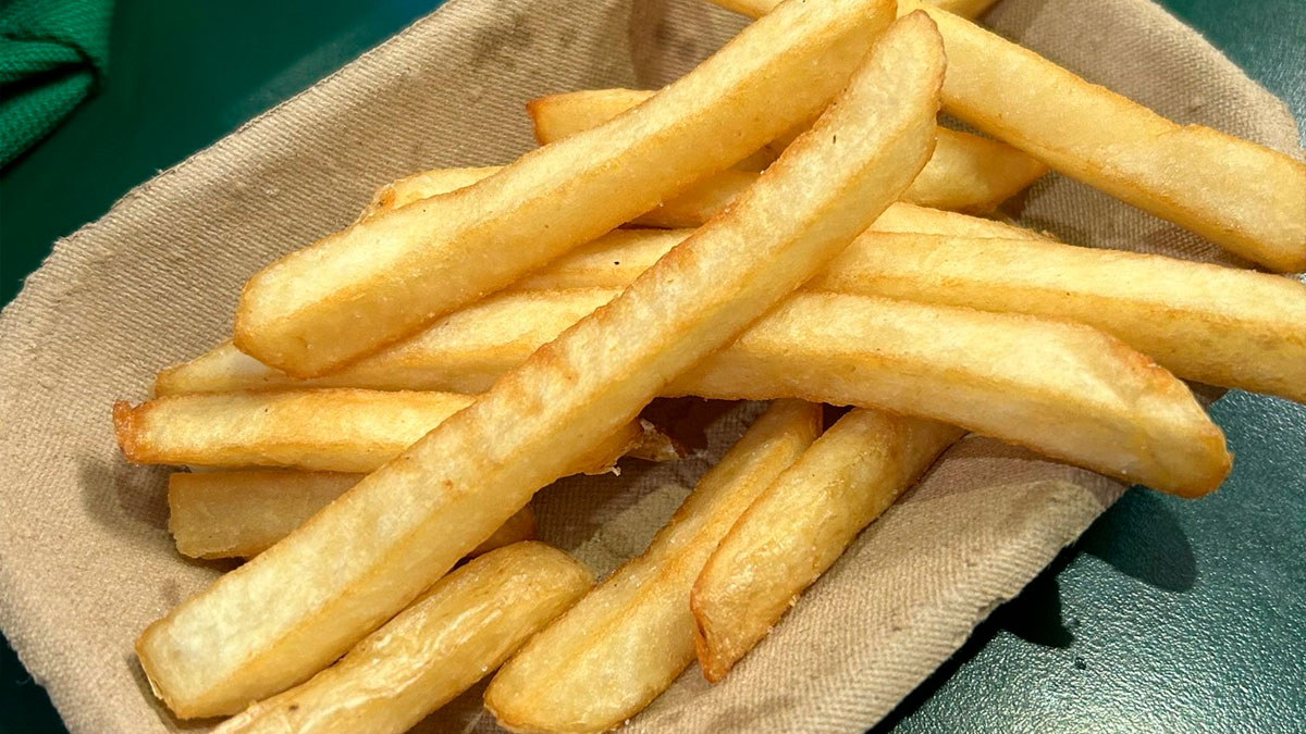 Close-up of smaller fast food fries in a paper tray illustrating products getting smaller and more expensive.