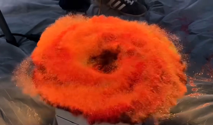 A vibrant orange explosion resembling a fiery vortex, capturing a moment of huge risk with no logical reason at all.