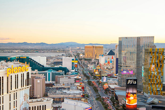 Aerial view of Las Vegas Strip at sunset showing brightly lit hotels and casinos capturing huge risks in urban scenes.