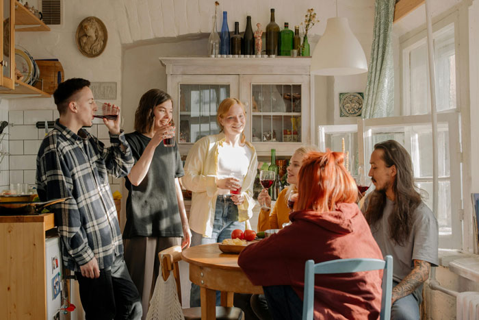 Group of students enjoying a house party while one student wonders if guests’ comfort justifies being asked to leave.