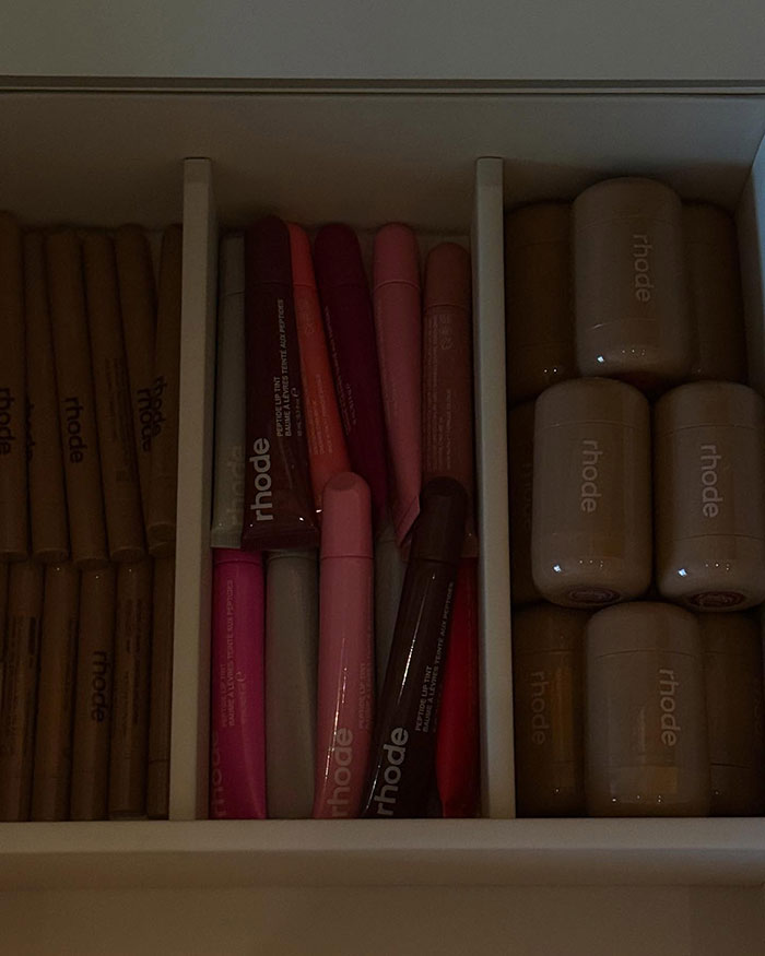 Makeup products neatly arranged in a drawer, showcasing various rhode cosmetics lip and face items. Makeup products neatly arranged in a drawer, showcasing various rhode cosmetics lip and face items.