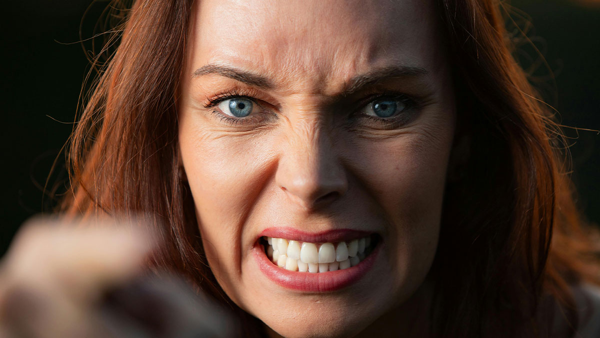Middle-aged woman with a shopping habit showing anger and frustration in a close-up portrait with intense expression