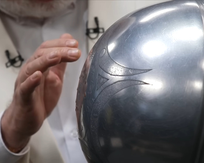 Scientist examining a metallic UFO object with mysterious inscriptions about origin of birth in a lab setting. Scientist examining a metallic UFO object with mysterious inscriptions about origin of birth in a lab setting.