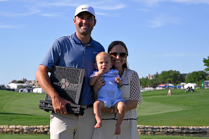 Scottie Scheffler holding golf trophy with family on course, showcasing golf’s financial power and rising superstar status