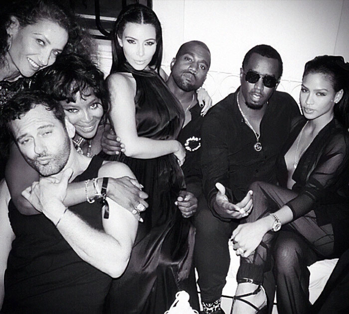Star-studded party in Ibiza with celebrities including Diddy, posing closely in a lively, black-and-white photo. Star-studded party in Ibiza with celebrities including Diddy, posing closely in a lively, black-and-white photo.