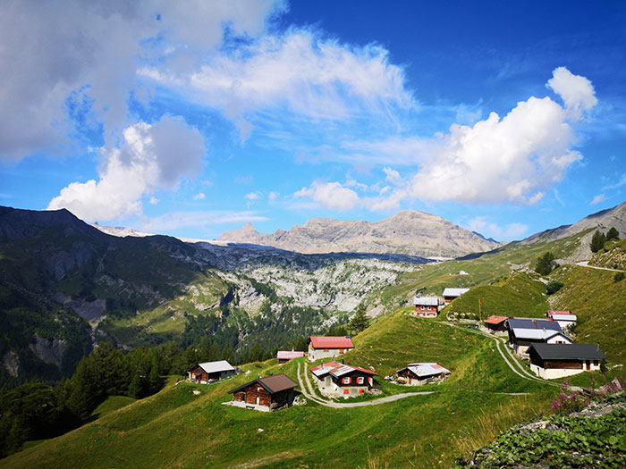 Scenic mountain village under blue sky illustrating charming national stereotypes in a picturesque landscape.