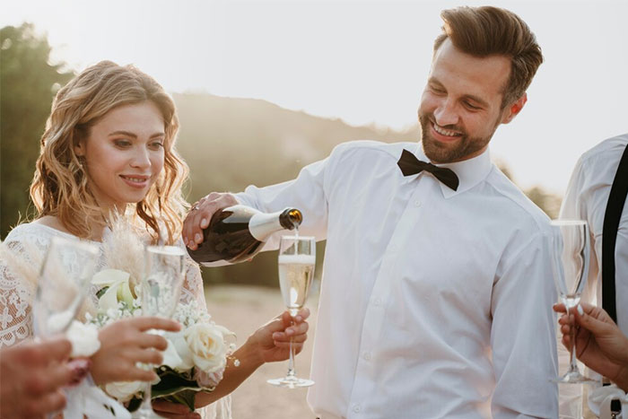Couple celebrating at a wedding with champagne, capturing a moment related to stopping a boyfriend’s proposal. Couple celebrating at a wedding with champagne, capturing a moment related to stopping a boyfriend’s proposal.