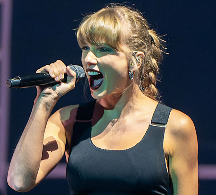 Taylor Swift performing on stage passionately singing, related to president Trump and White House response. Taylor Swift performing on stage passionately singing, related to president Trump and White House response.