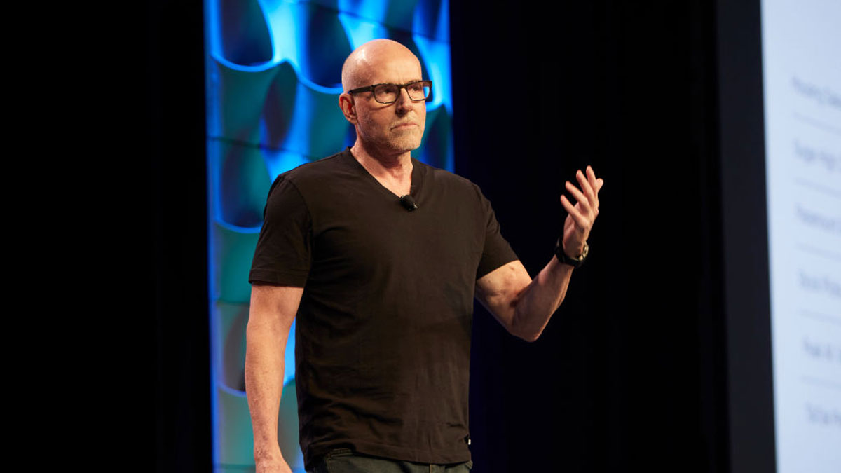 Scott Galloway wearing glasses and black shirt, speaking on stage about money rules driving net worth growth.