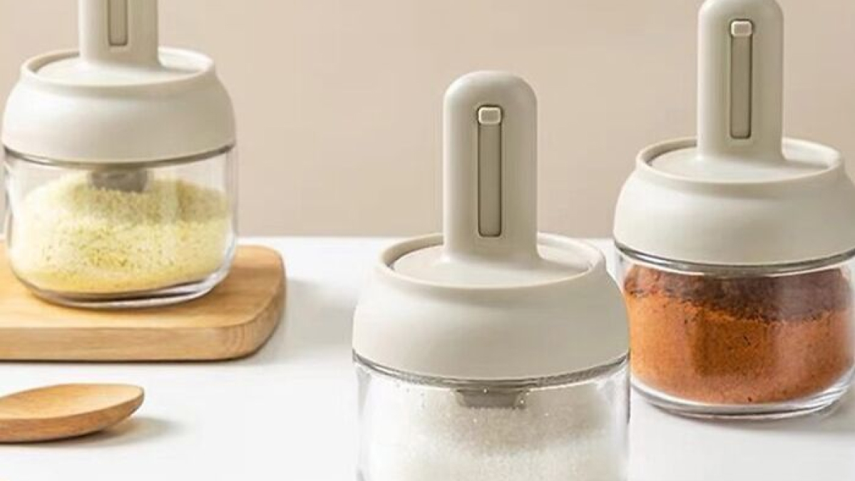 Smart kitchen gadgets including modern spice containers with white lids on a clean countertop for upgraded kitchen IQ.