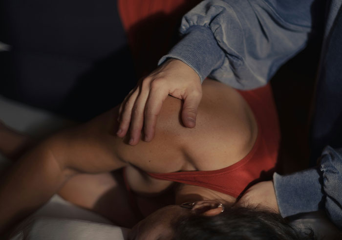 Person comforting another by placing hand on shoulder, illustrating moments that could completely destroy people’s lives.