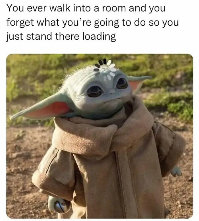 Baby Yoda wearing a brown coat with a loading symbol on its forehead, illustrating relatable human experience meme.
