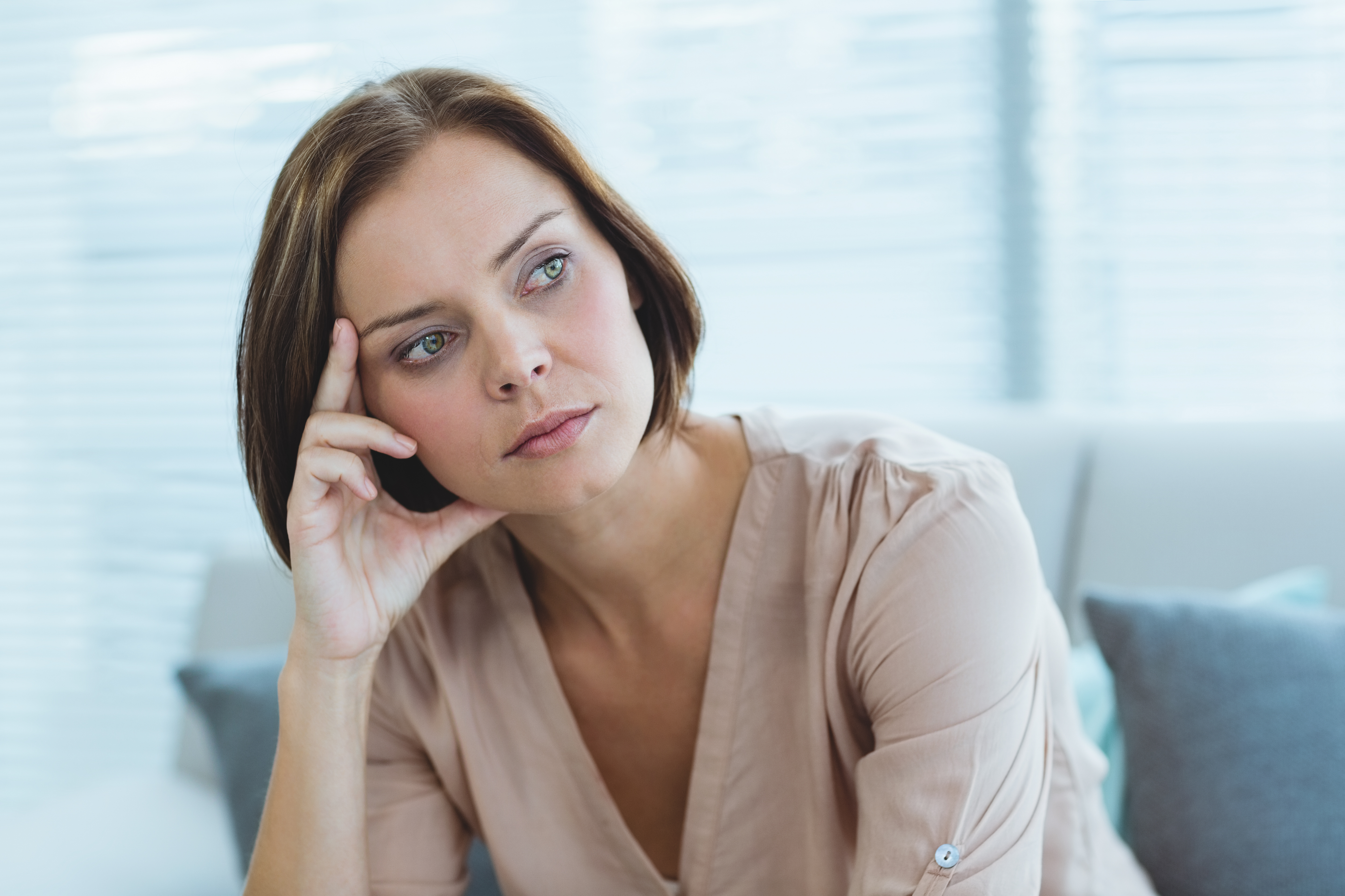 Thoughtful woman sitting indoors, reflecting on a difficult moment involving her husband’s childhood best friend favor request. Thoughtful woman sitting indoors, reflecting on a difficult moment involving her husband’s childhood best friend favor request.