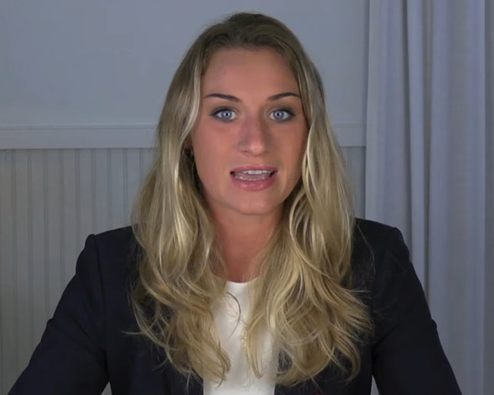 Woman with long blonde hair in a black blazer speaking in a video about trad-wife influencer defending white mom fundraiser. Woman with long blonde hair in a black blazer speaking in a video about trad-wife influencer defending white mom fundraiser.