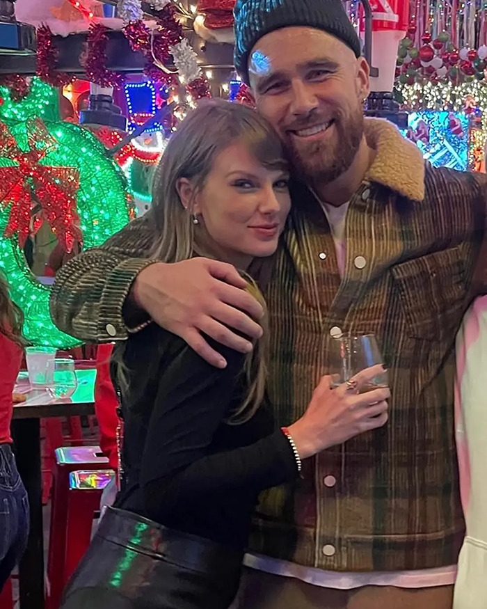 Taylor Swift smiling with a man in a festive setting, highlighting her brutal interrogation by Barbara Walters.