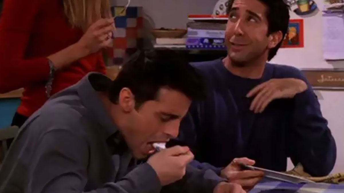 Scene from a popular TV show featuring actors laughing and eating, highlighting behind-the-scenes movie and TV facts.