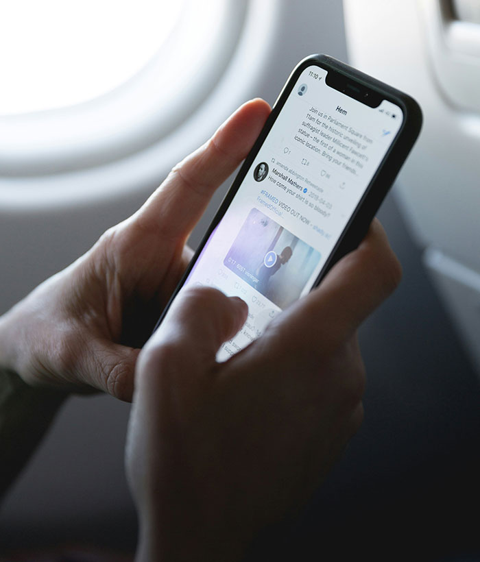 Person holding smartphone showing social media app, illustrating father of four with 37 followers jailed over deleted tweet. Person holding smartphone showing social media app, illustrating father of four with 37 followers jailed over deleted tweet.