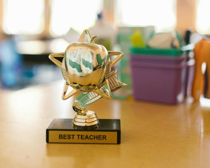 Golden best teacher trophy in the shape of an apple and star, symbolizing teacher appreciation week deals and special offers. Golden best teacher trophy in the shape of an apple and star, symbolizing teacher appreciation week deals and special offers.
