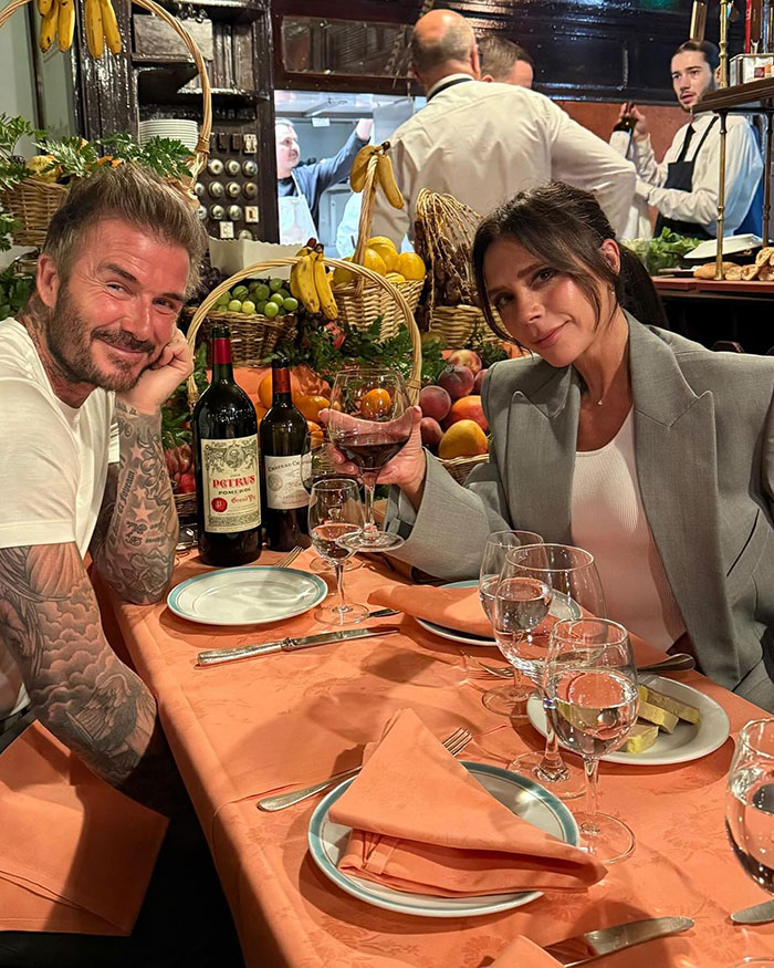 David Beckham and Victoria Beckham at a dinner table with wine and fruit, amid birthday party family feud rumors. David Beckham and Victoria Beckham at a dinner table with wine and fruit, amid birthday party family feud rumors.