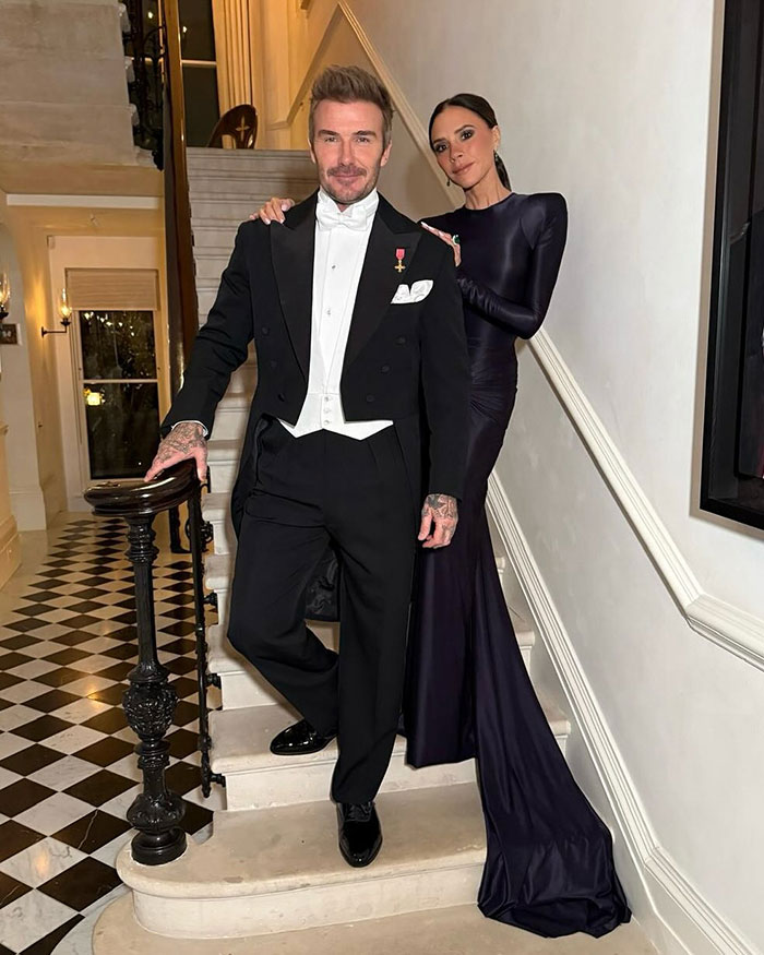 Victoria Beckham and her son posing on stairs at formal event, linked to wedding drama involving Nicola Peltz. Victoria Beckham and her son posing on stairs at formal event, linked to wedding drama involving Nicola Peltz.