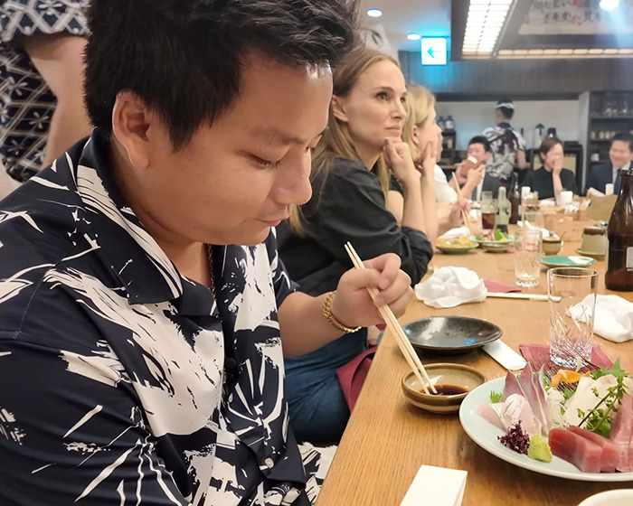Vlogger sitting next to A-List star at a restaurant, unaware while recording entire video with chopsticks and sashimi. Vlogger sitting next to A-List star at a restaurant, unaware while recording entire video with chopsticks and sashimi.