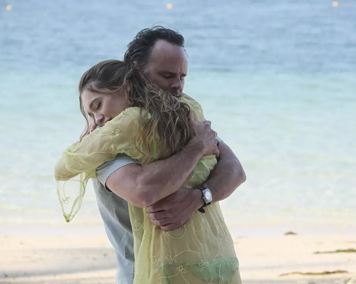 Walton Goggins and Aimee Lou Wood hugging on a beach scene, highlighting Walton Goggins off the rails moment. Walton Goggins and Aimee Lou Wood hugging on a beach scene, highlighting Walton Goggins off the rails moment.