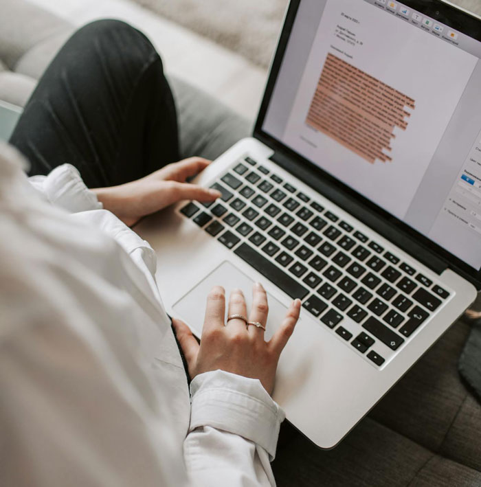 Person working on laptop with highlighted text, representing interview task and realization of being tricked during interview process. Person working on laptop with highlighted text, representing interview task and realization of being tricked during interview process.