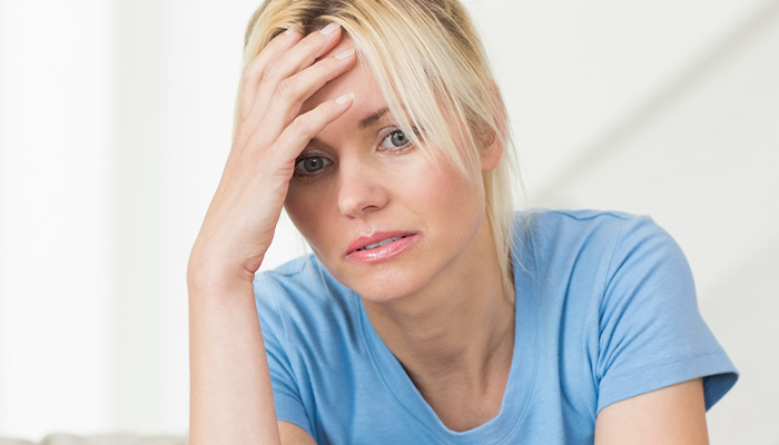 Stressed woman in blue shirt setting boundaries with friend after feeling used and overwhelmed by toddler hosting requests. Stressed woman in blue shirt setting boundaries with friend after feeling used and overwhelmed by toddler hosting requests.