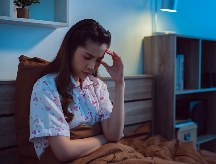 Woman sitting in bed looking worried and stressed, debating calling CPS after learning about niece’s home life. Woman sitting in bed looking worried and stressed, debating calling CPS after learning about niece’s home life.