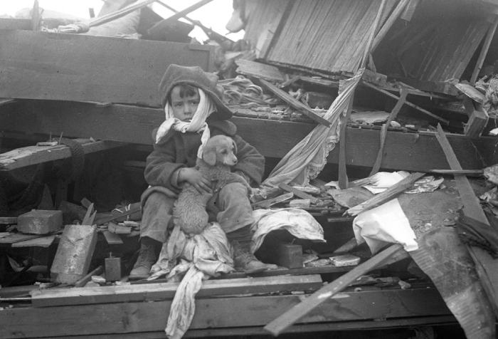 Boy sitting among tornado debris holding a puppy, illustrating the worst tornado in US history with lives lost. Boy sitting among tornado debris holding a puppy, illustrating the worst tornado in US history with lives lost.