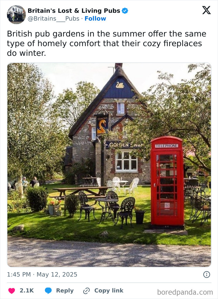 British pub garden with cozy outdoor seating and a classic red phone booth, showcasing British comedians' humor.