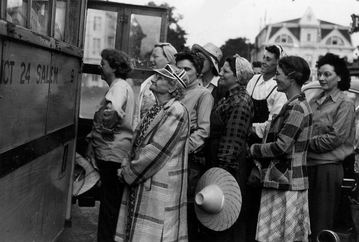 Group of 1940s housewives lined up outdoors, wearing period clothing and hats, capturing iconic 1940s housewives history.