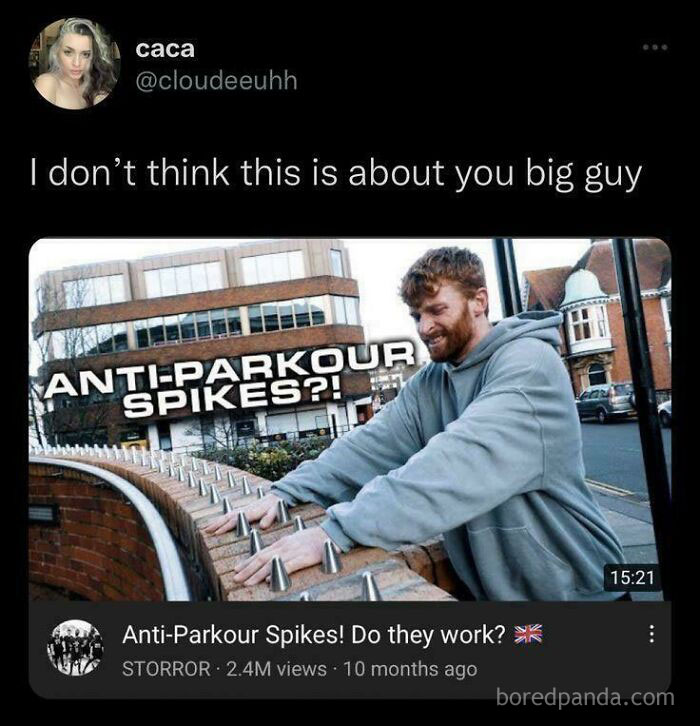 A man in a gray hoodie inspecting anti-parkour spikes on a wall in a meme asking to explain the joke.
