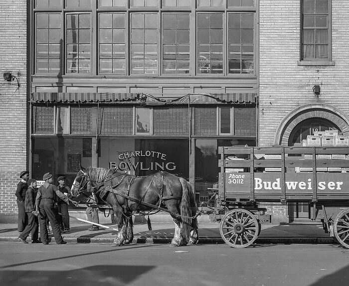 Colorized historical photo of a Budweiser horse-drawn wagon and children outside Charlotte Bowling alley.