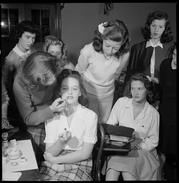 Colorized historical photo of women applying makeup and observing, showcasing magical historical photos by a talented viral artist.