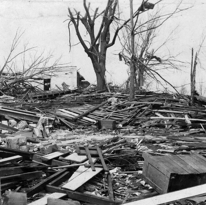 Black and white image of extensive tornado damage with debris and broken trees, depicting the worst tornado in US history. Black and white image of extensive tornado damage with debris and broken trees, depicting the worst tornado in US history.