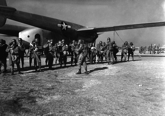 African American soldiers preparing to board a military aircraft during World War II, highlighting African American military history.