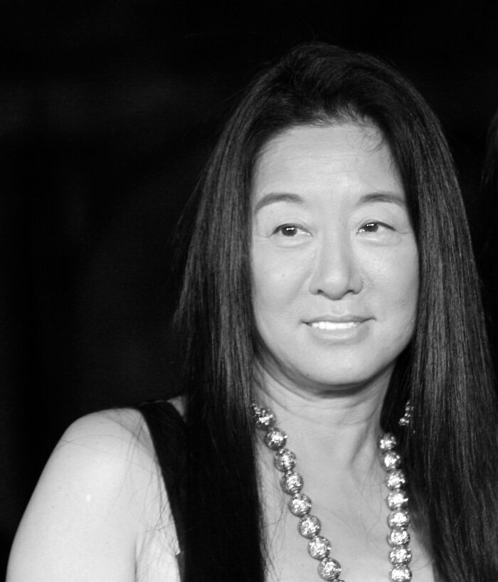 Woman with long dark hair and beaded necklace, representing late bloomers who became millionaires after being counted out.