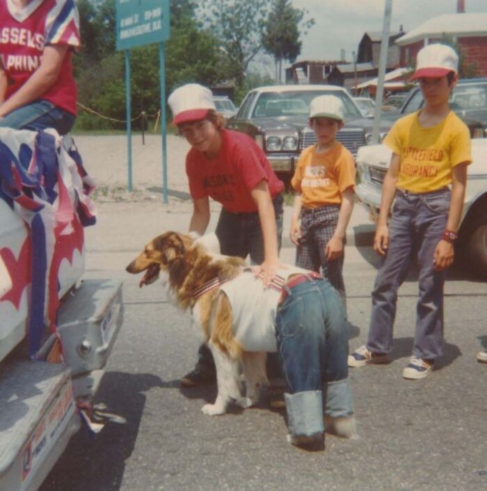 Children and a dog dressed in jeans and hats in a vintage photo capturing a unique moment from history.