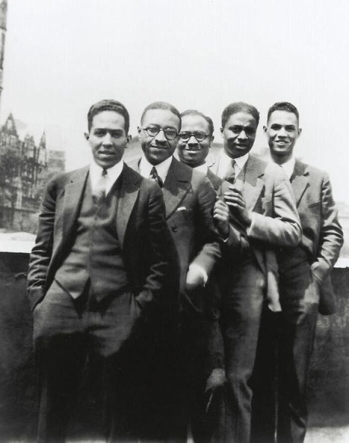 Group of African American men in suits posing outdoors, capturing key moments of the Harlem Renaissance era.
