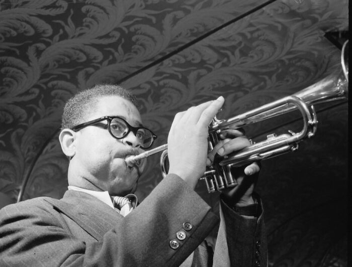 African American musician playing trumpet, capturing a defining moment of the Harlem Renaissance era in history.