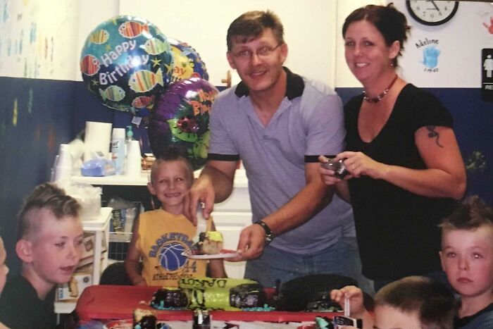 Family celebrating a birthday with balloons and cake, a dad cherishing memories of his late son&rsquo;s heartbeat teddy bear.