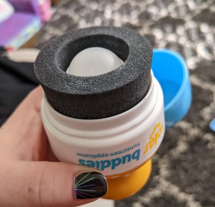 Sunscreen applicator with sponge top held in hand to help fight back summer annoyances like sunburn and heat.