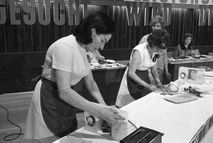 1940s housewives participating in a home appliance demonstration, showcasing domestic skills and household management.