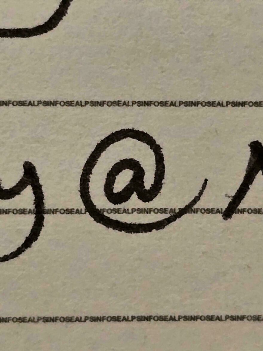 Close-up of perfect handwriting example showing black ink on textured paper, highlighting clear and neat penmanship details.