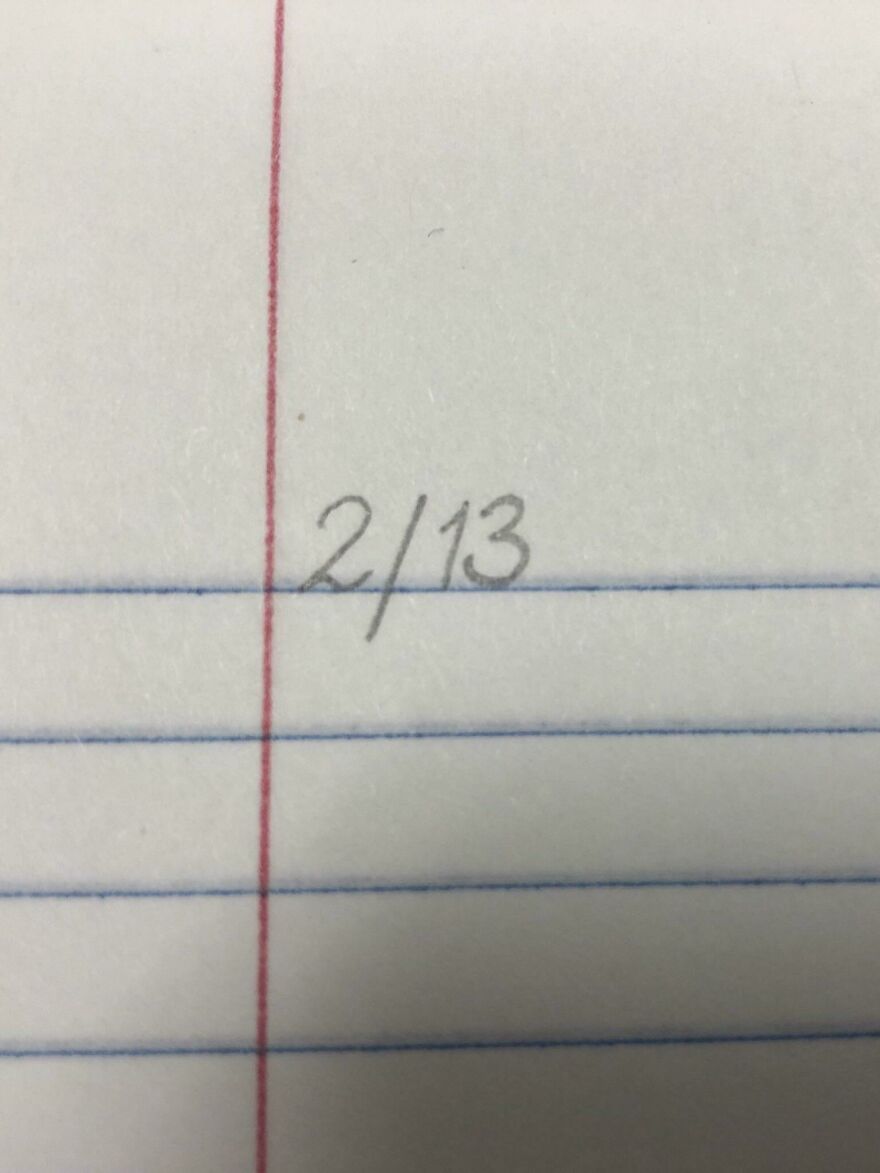 Perfect handwriting example of date written neatly in pencil on lined notebook paper with red and blue lines.