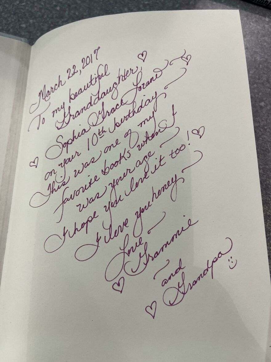 Handwriting example in elegant cursive with decorative hearts, showcasing perfect handwriting and calligraphy skills.