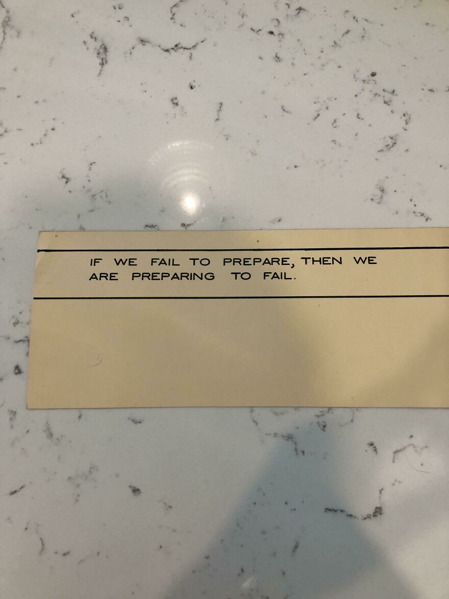 Handwriting example on beige paper with the quote about preparation, showing perfect handwriting style.