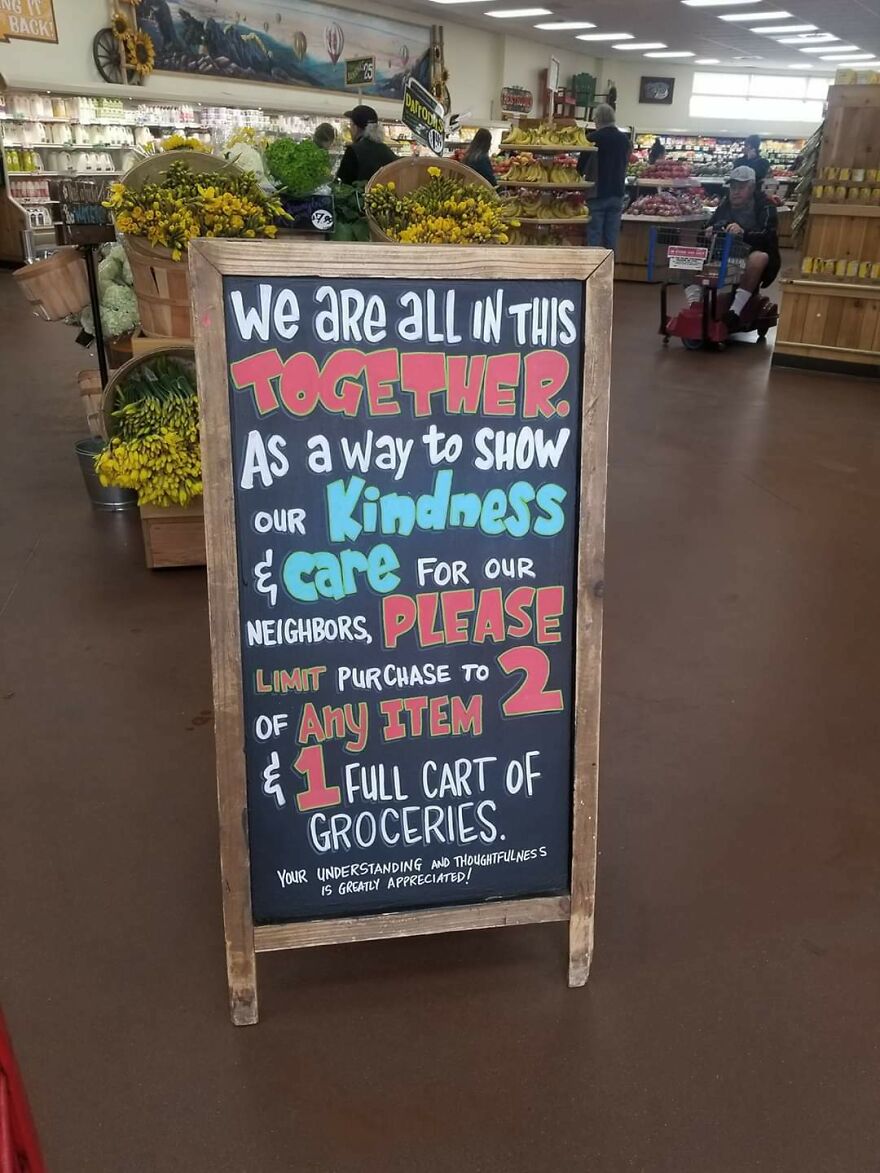 Chalkboard sign with perfect handwriting showing a grocery purchase limit message in a store setting.