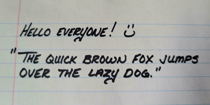 Neat handwriting example featuring the phrase the quick brown fox jumps over the lazy dog on lined paper.